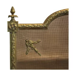 A richly sculpted Louis XVI gilt bronze ribbon fire screen