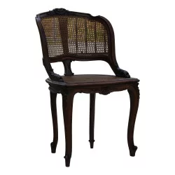 A richly carved caned armchair