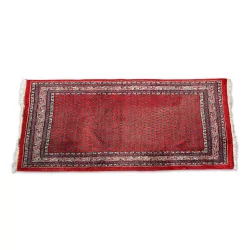 Oriental rug in blue, red, black and white with