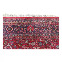 Large oriental rug in red tones.