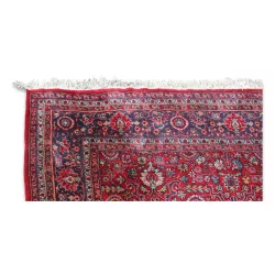 Large oriental rug in red tones.