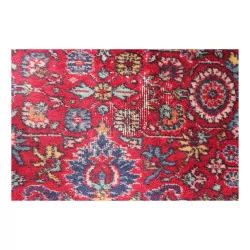 Large oriental rug in red tones.