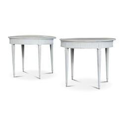 A pair of half-moon tables in white painted wood