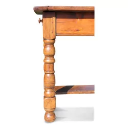 A rustic walnut table, carved legs