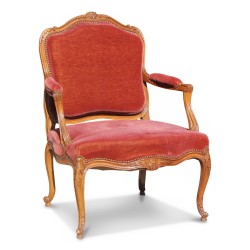 A molded walnut seat with pink velvet