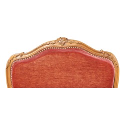 A molded walnut seat with pink velvet