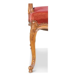 A molded walnut seat with pink velvet