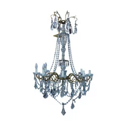 A French chandelier in gilded metal, zaponné with crystals, eight lights