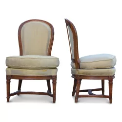 A pair of beech seats covered in beige fabric