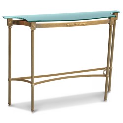 A sofa back in gold metal and glass top