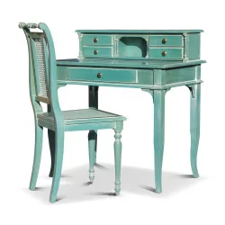 A desk with aqua green cane chair