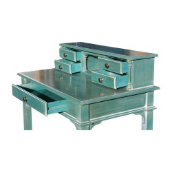 A desk with aqua green cane chair