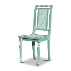 A desk with aqua green cane chair