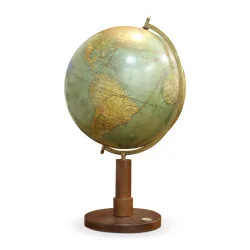 A world map with wooden base and compass