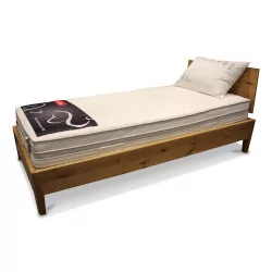A “Roviva” bed frame in knotty oak