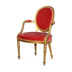 A pair of gilded wood seats covered in red velvet