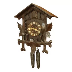 A richly carved wooden wall clock
