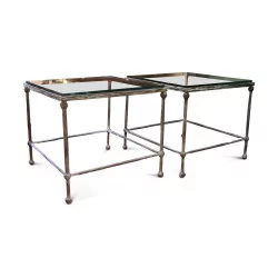 A pair of bronze end tables, glass top