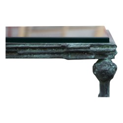 A pair of bronze end tables, glass top