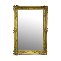 A mirror with a richly molded gilded frame