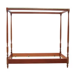 A canopy bed in mahogany wood