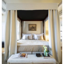 A canopy bed in mahogany wood