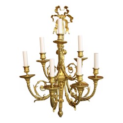 A molded gilt bronze light fixture, seven lights