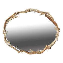 An oval mirror with a deer antler frame.