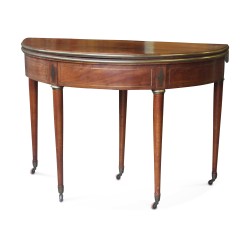 A circular games table in mahogany and veneer wood