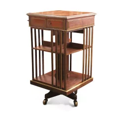 A revolving storage unit \"Revolving bookcase\" in mahogany decorated with brass