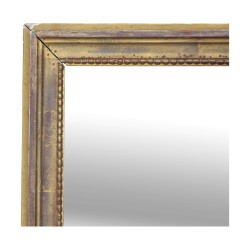 A mirror with gold frame, “Pearl” decor molding