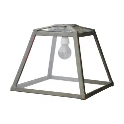 An outdoor light in patinated metal and glass