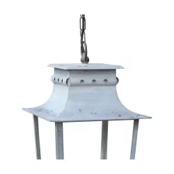 An outdoor light fixture in painted sheet metal with white patina and glass