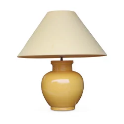 A yellow porcelain light fixture with yellow lampshade