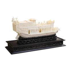 An ornately carved ivory boat sculpture