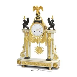 A Louis XVI clock richly decorated with chiseled gilded bronzes