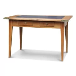 A cherry wood table with a central slate top, two drawers