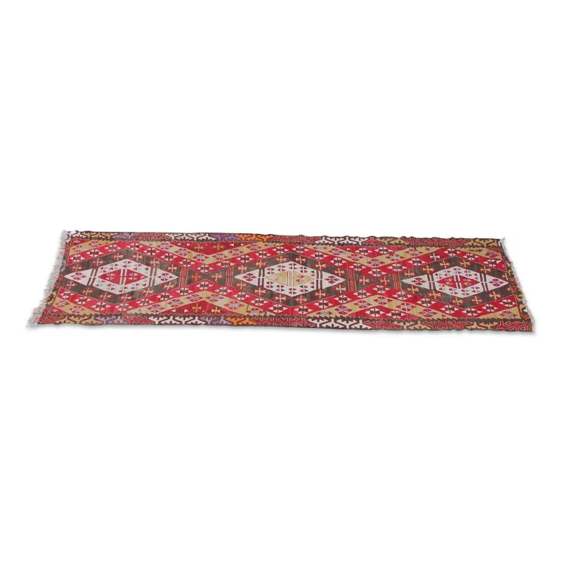 Ein „Kelim“-Teppich aus Wolle in den Farben Rot, Weiß, Gelb und Blau. - Moinat - Teppiche
