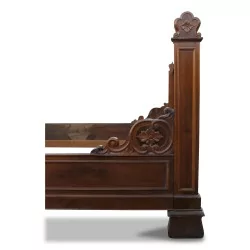 A richly carved walnut bedpost.