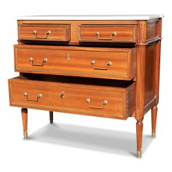 A Louis XVI mahogany chest of drawers, mounted on oak, with four drawers.