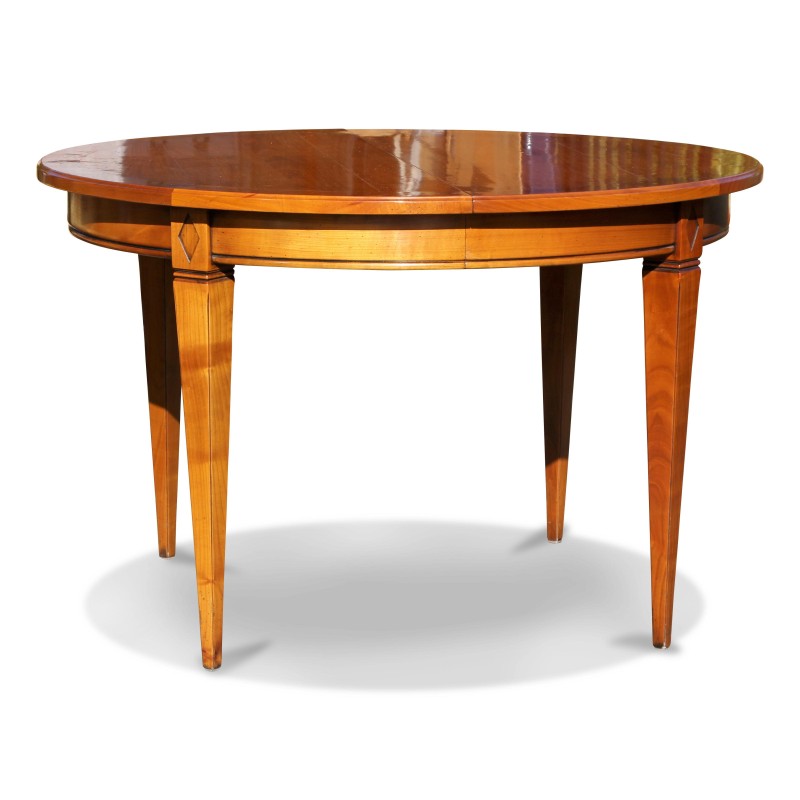 Un table ronde directoire en merisier de la collection "Richelieu", chevillée avec deux rallonges - Moinat - Tables de salle à manger