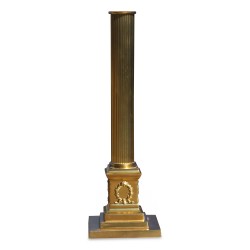 A brass Corinthian column lamp with white shade