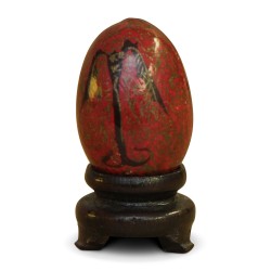 a Russian wooden egg with red and black decor