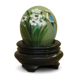 A green jade stone egg with Chinese decor