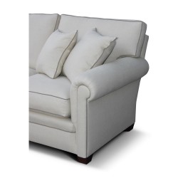 A three-seater \"Bahamas\" sofa covered in beige linen fabric and gray piping