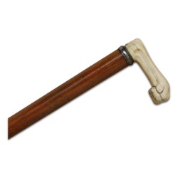 A wooden cane with ivory cross
