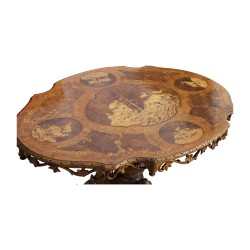 A richly carved “Brienz” dining table, tripod