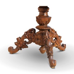 A richly carved “Brienz” dining table, tripod