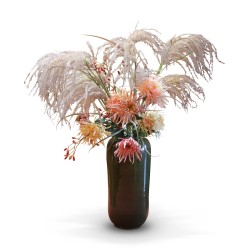 A green earthenware vase with a bouquet of synthetic flowers