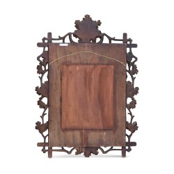 A mirror mounted on a richly carved “Brienz” panel